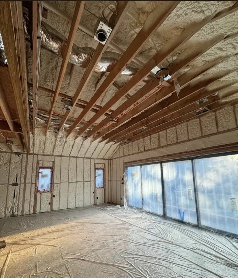 Interior walls and ceiling insulated with spray foam during new construction in Baxter Village
